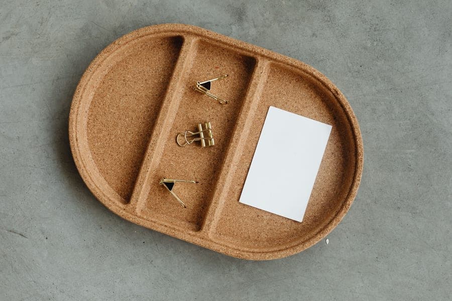 A desktop paper tray and drawer organizer on a wooden desk